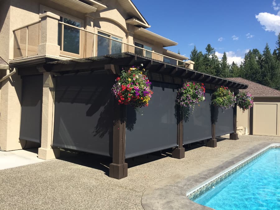 retractable screens covering backyard patio